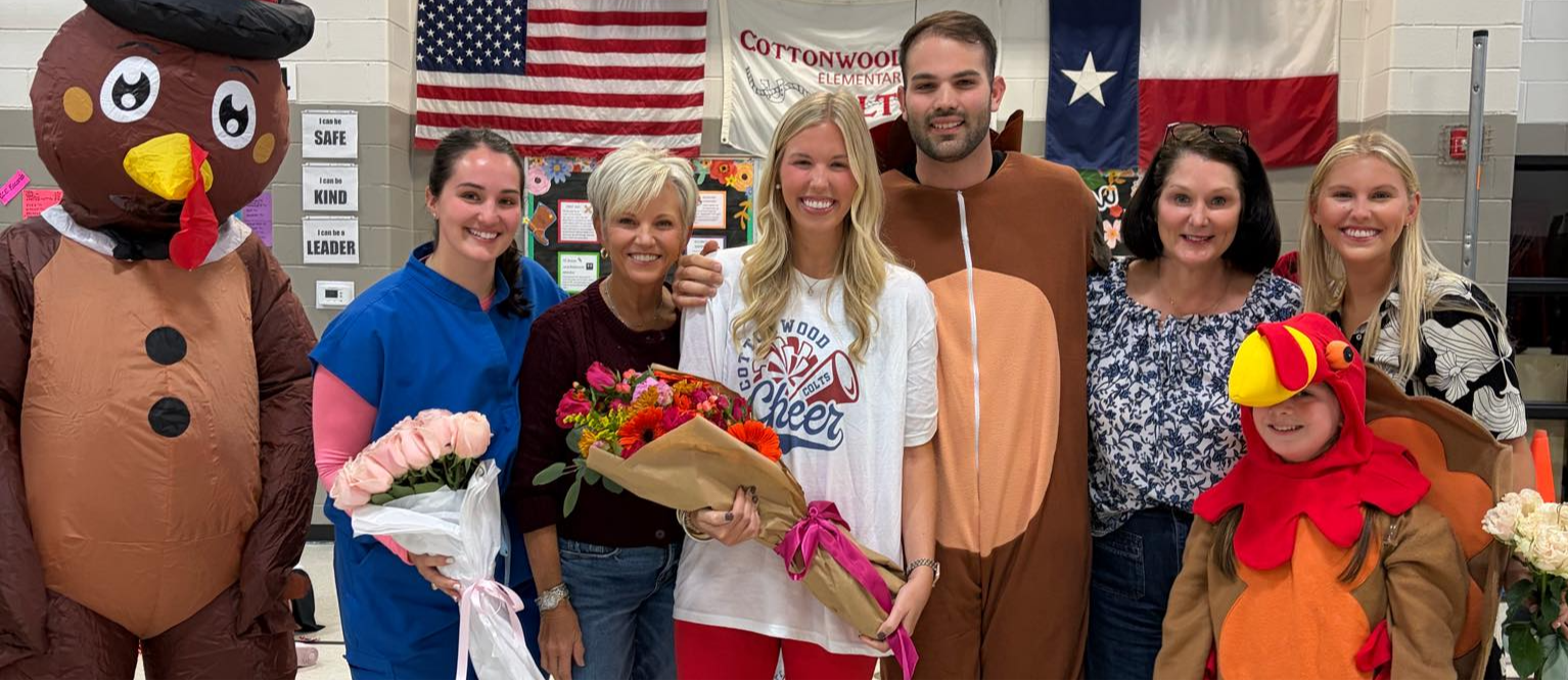 teacher of the year photo with an inflatable turkey, and child in a turkey suit