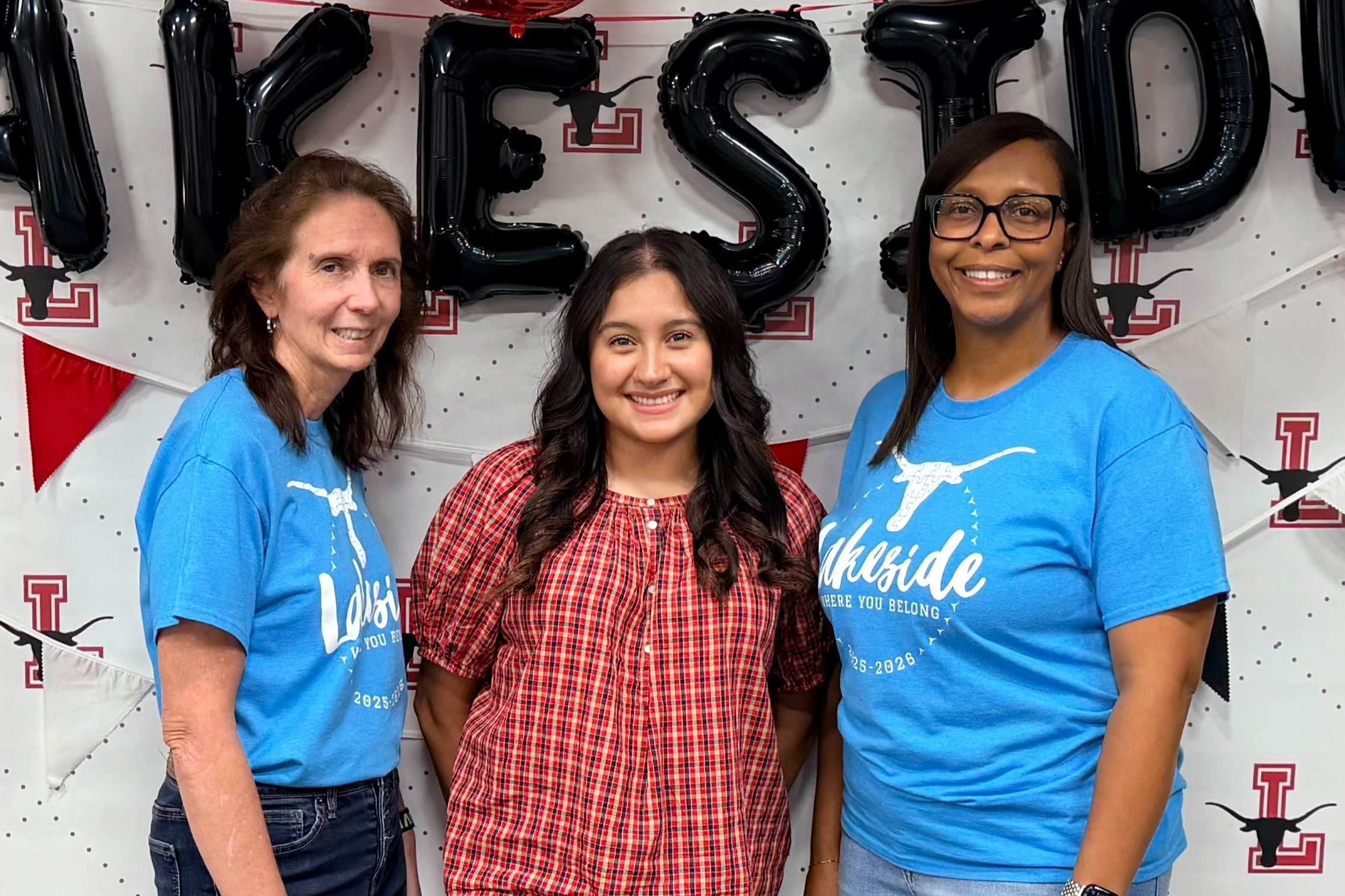 The image is of the third grade teachers standing in front of the Lakeside banner.