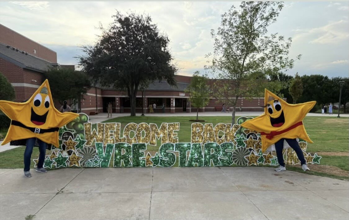 Star mascots with welcome back sign