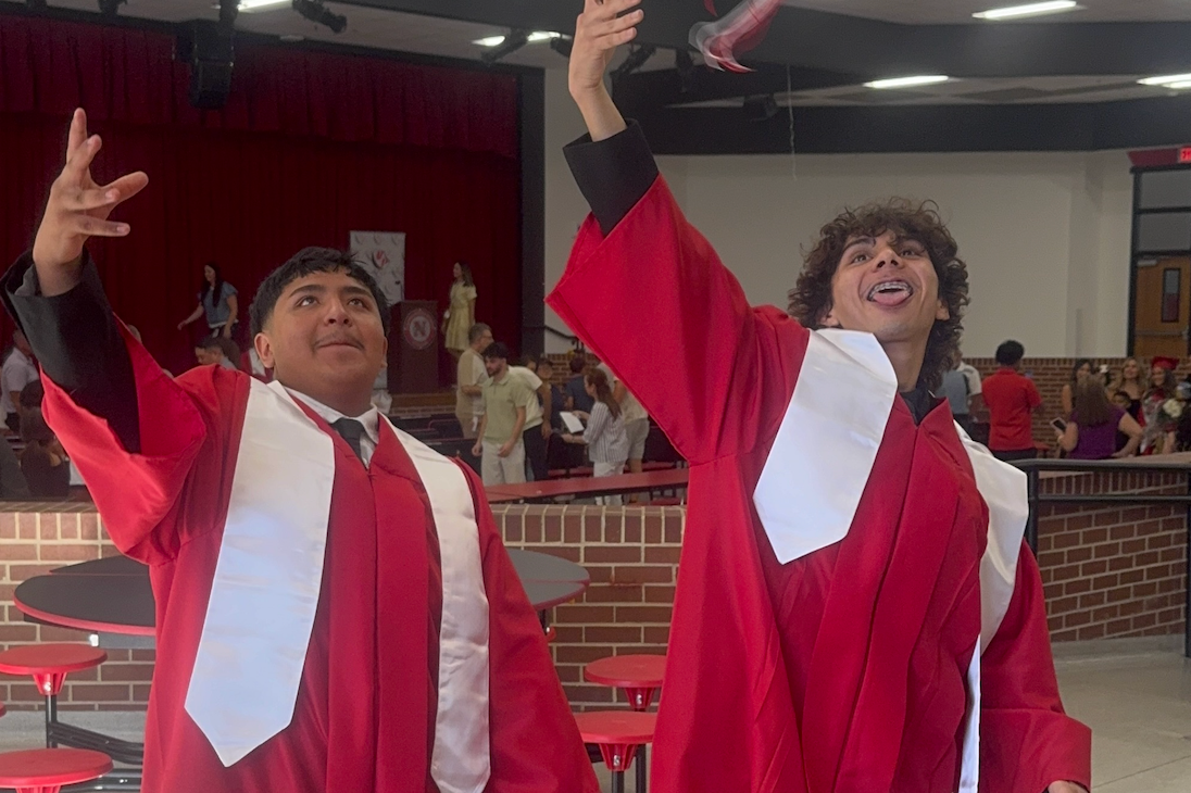 Two students throw their red graduation caps into the air after the first Turning Point graduation of the 2026-27 school year.