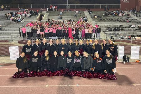 Cheer team takes a photo with the student section during the 2022 football season.