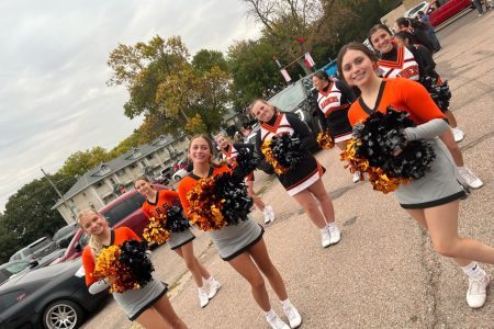 Cheer team prepares to cheer during the homecoming parade fall 2022.