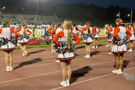 Our team gets their cheer on at a Raiders football game.