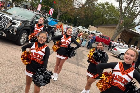Cheer team prepares to cheer during the homecoming parade fall 2022.