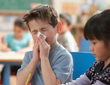 Child blowing nose in classroom
