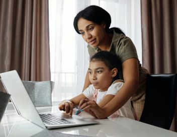 Parent Works with child on computer