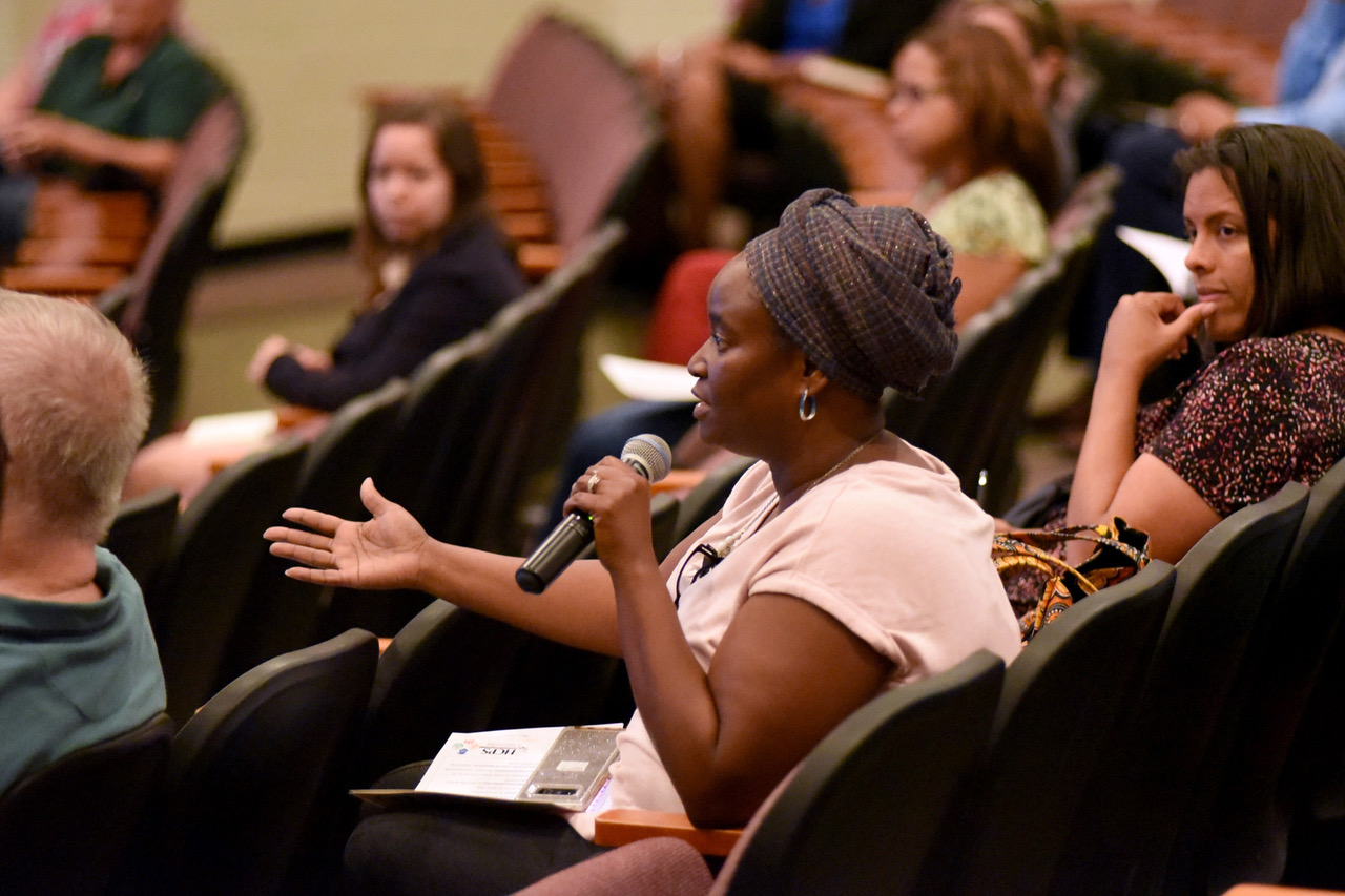 Woman asking question at Bridge Builders Academy session