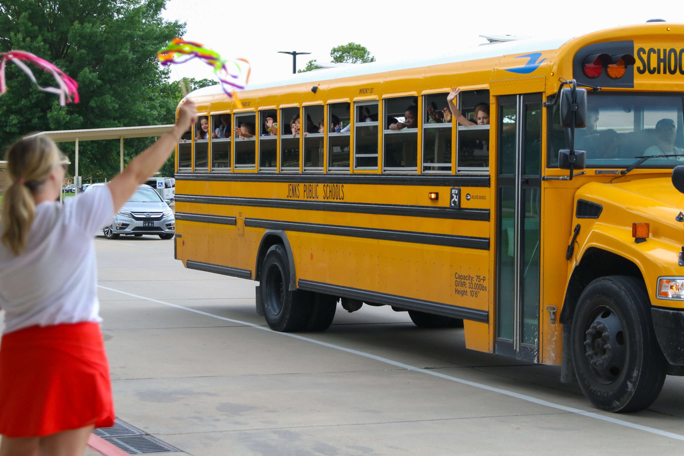 Jenks Public Schools bus with kids waving