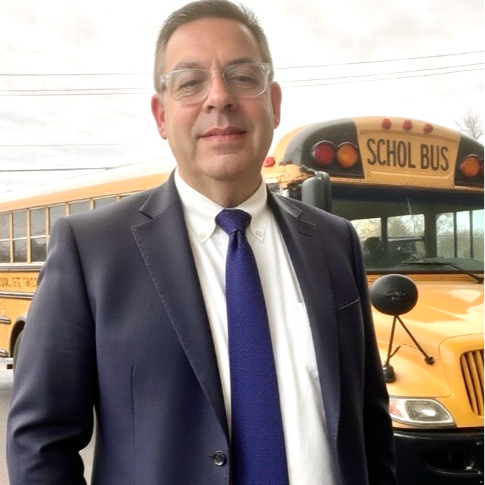 brad smythe in front of school bus