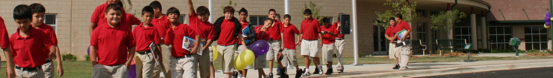 A group of students in uniform crossing the street