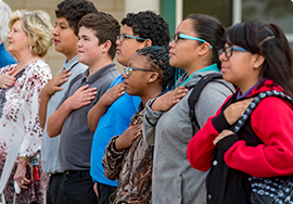 Students saying the Pledge of Allegiance with their hands over their hearts 