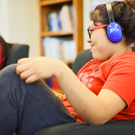 A student in the library using headphones