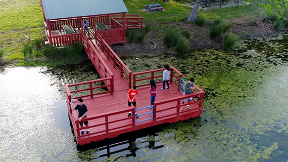 Students fishing on a dock