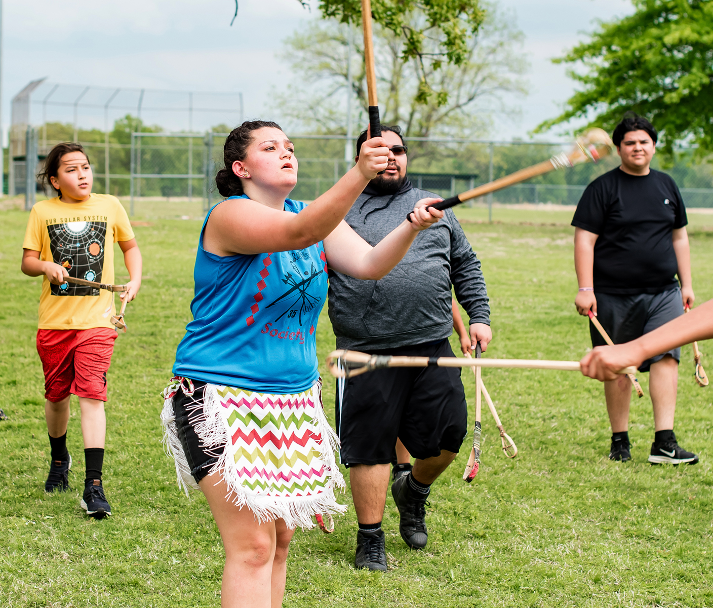 Students playing stickball