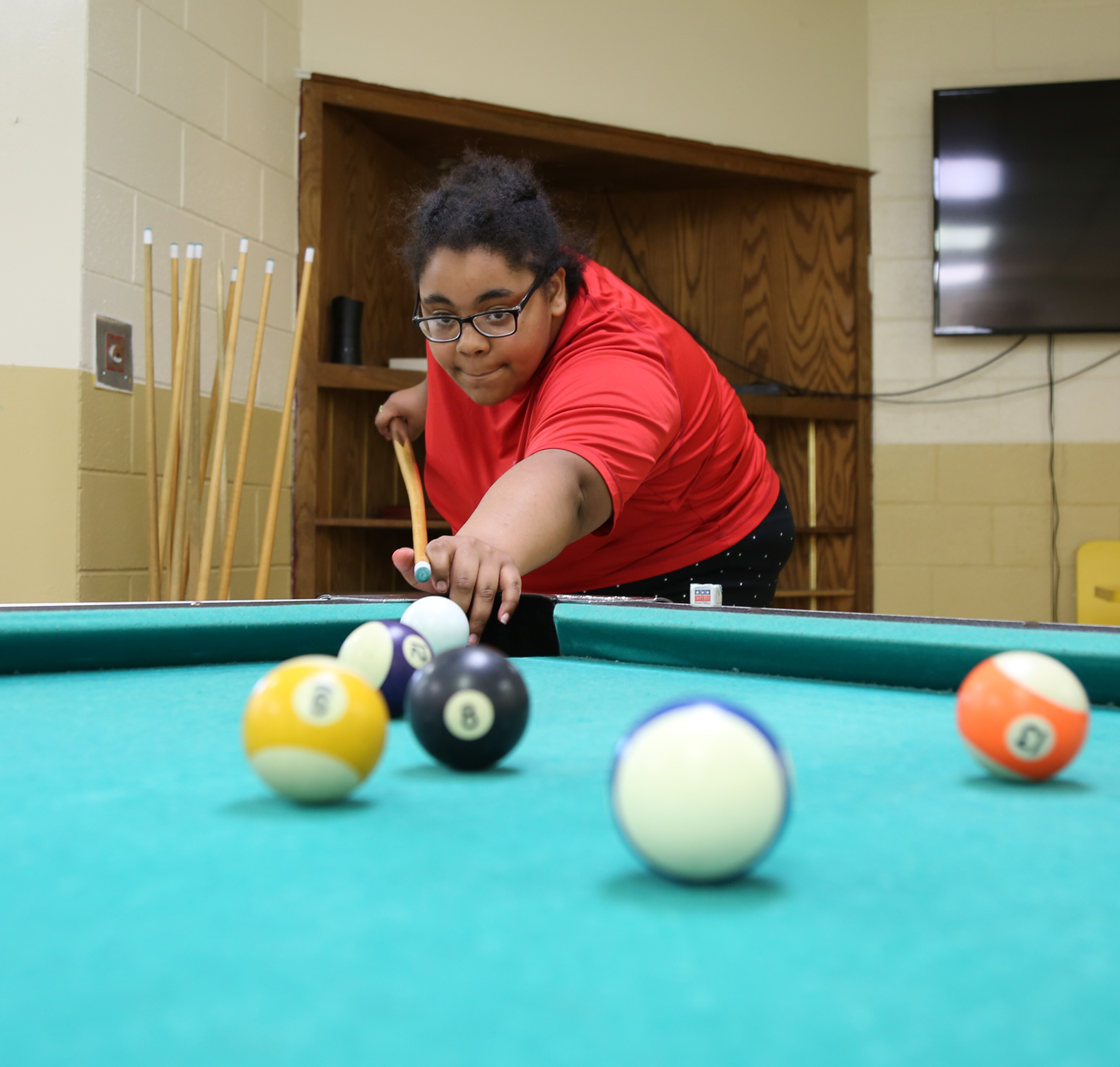 A student playing pool