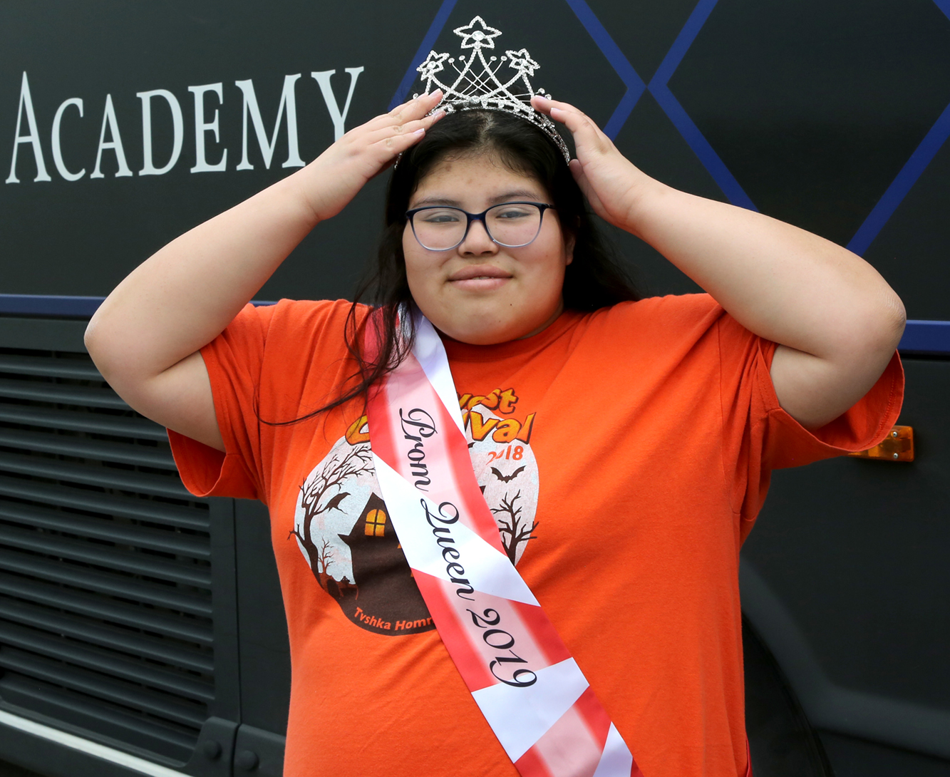 A student putting on a crown