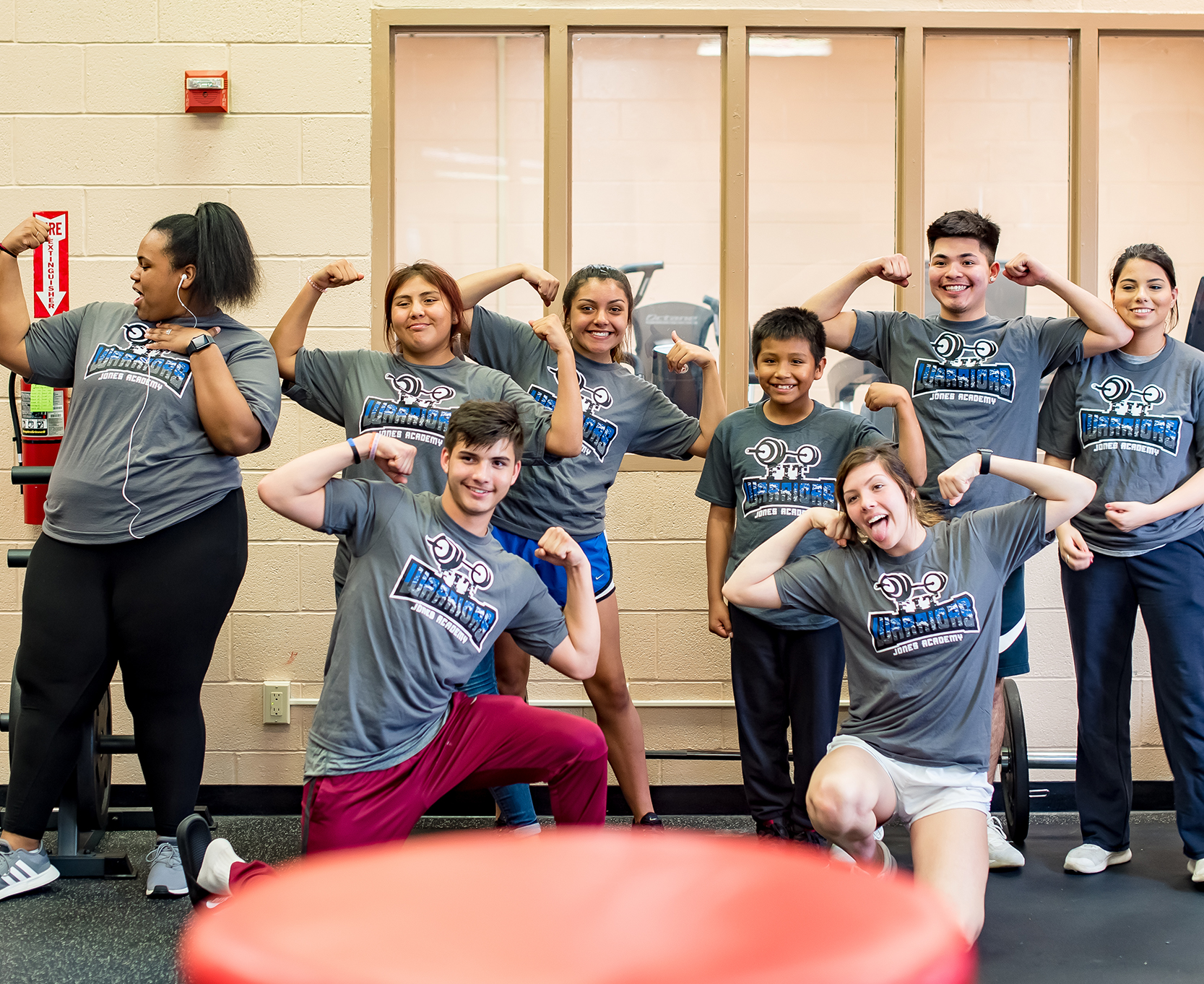 Students flexing their muscles as a group for the photo