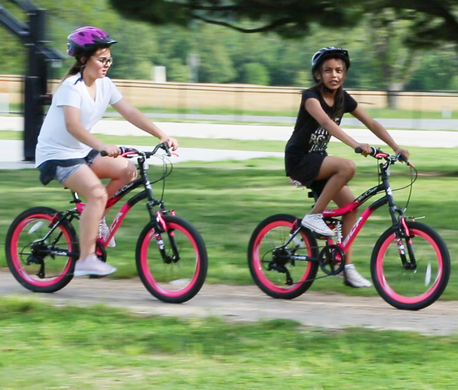 Two students riding bicycles together