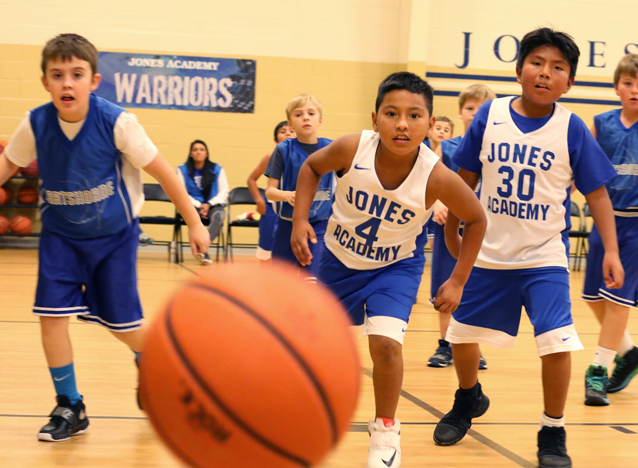 Students playing basketball in the gym