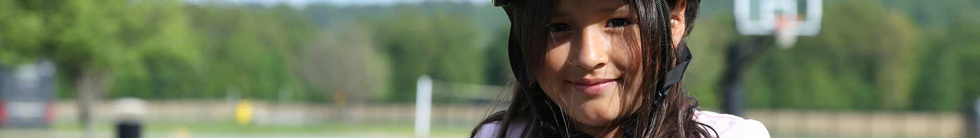 A closeup of a student outside with a helmet on