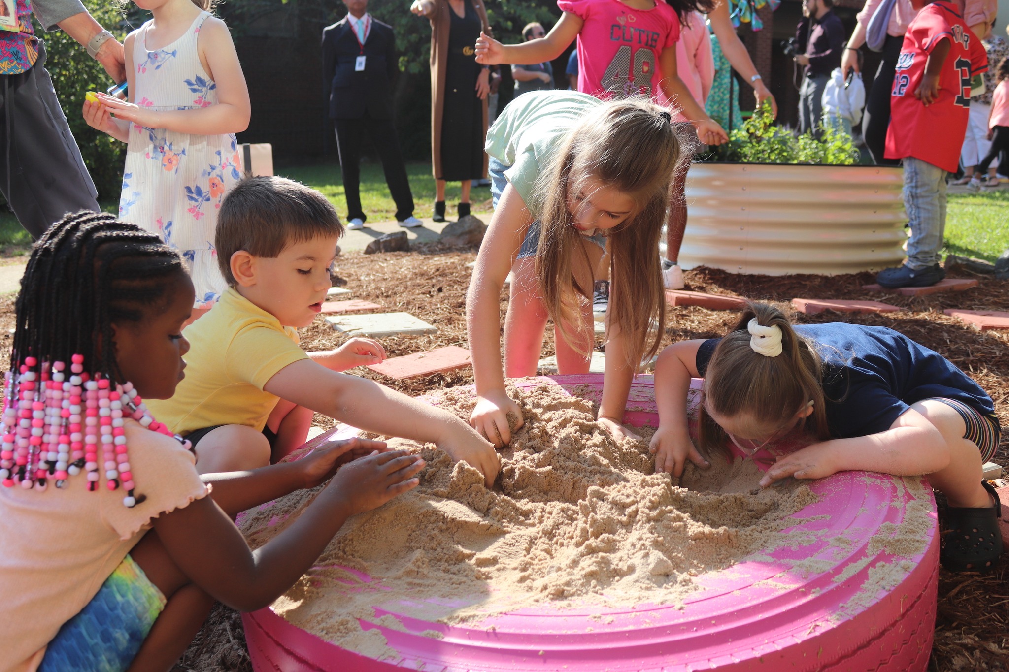 students playing in sandbox