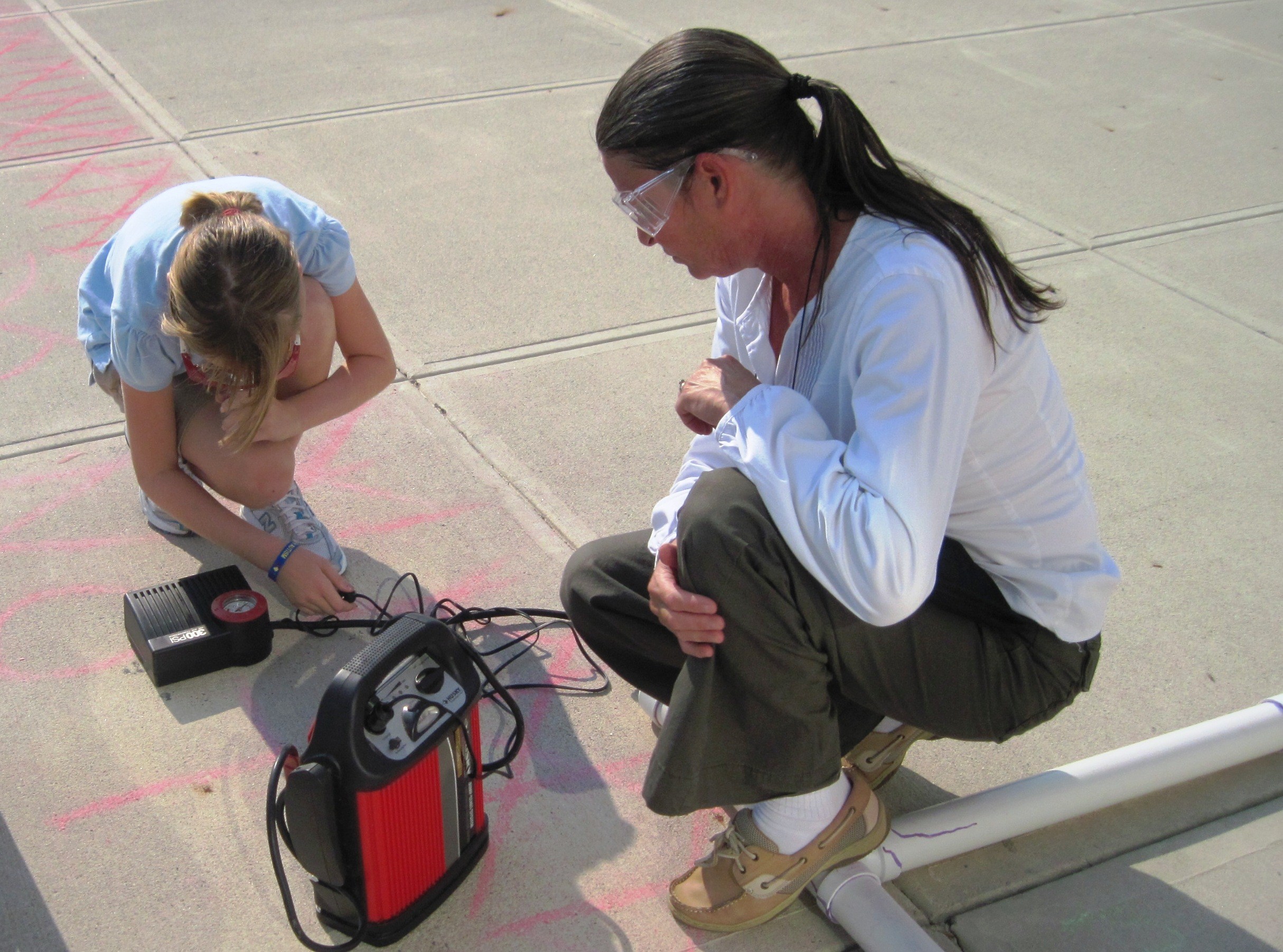 photos of science staff doing experiments with students