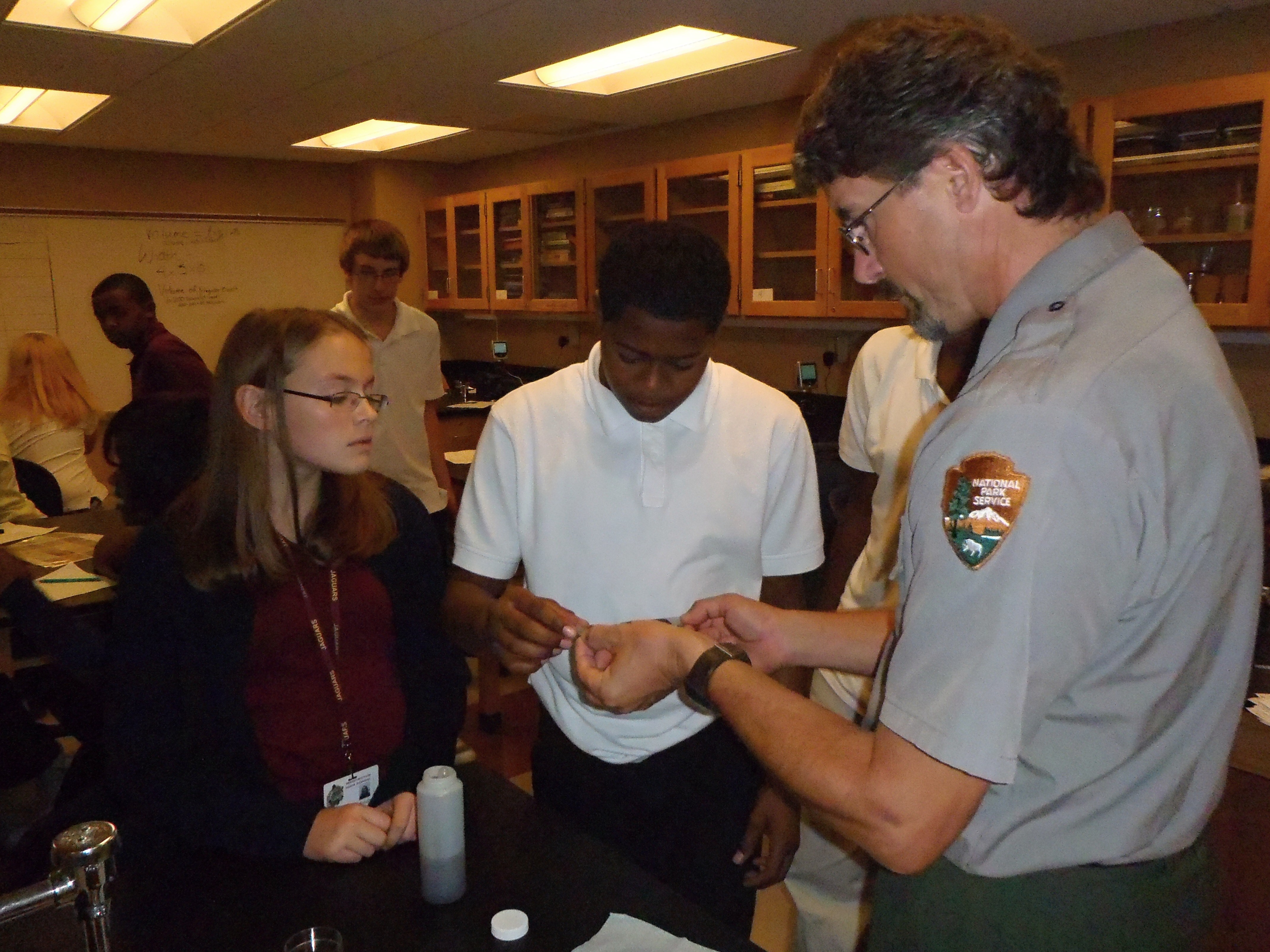 photos of science staff doing experiments with students