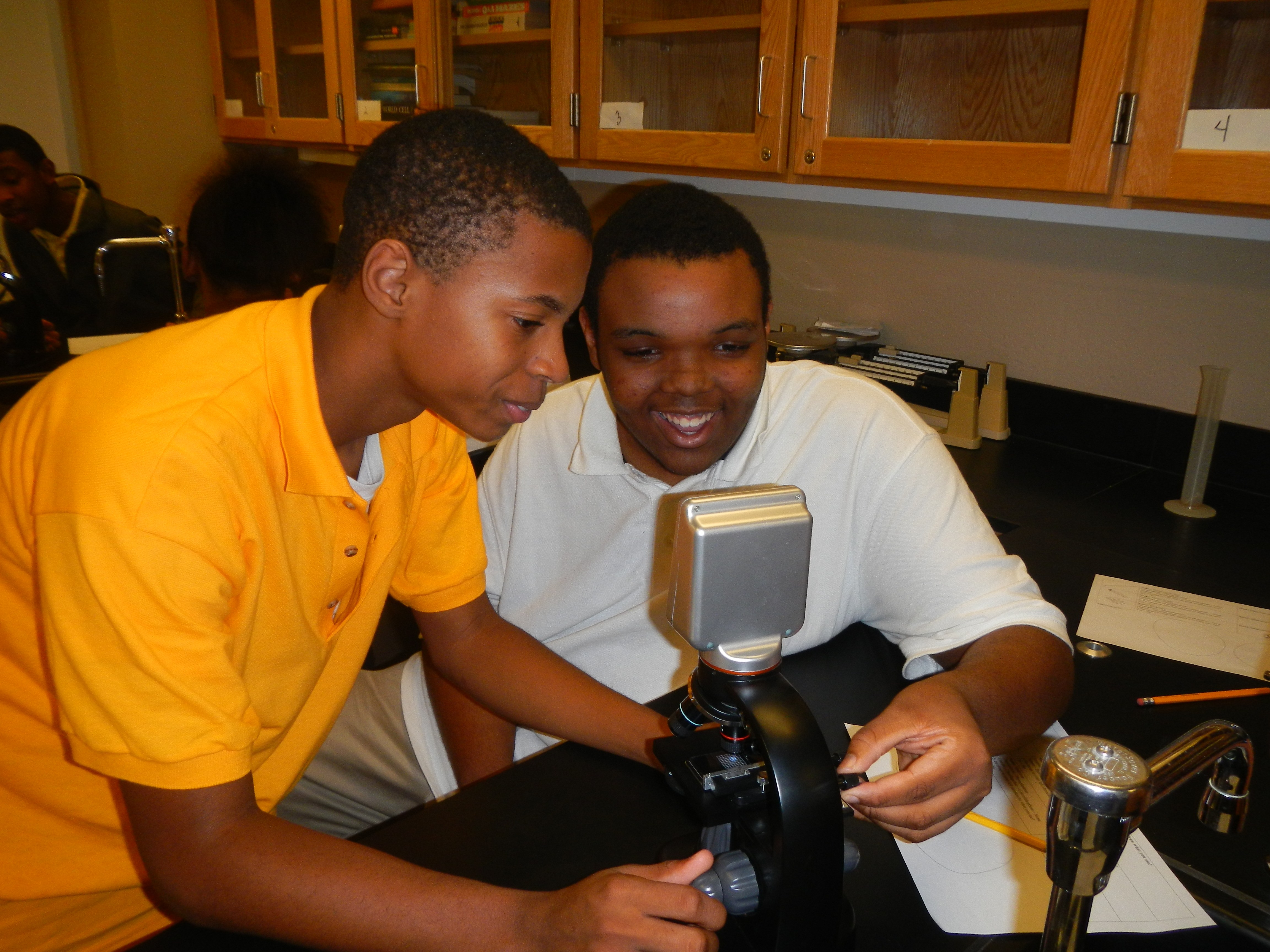 photos of science staff doing experiments with students