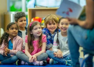 Kindergarten children sitting on the floor.