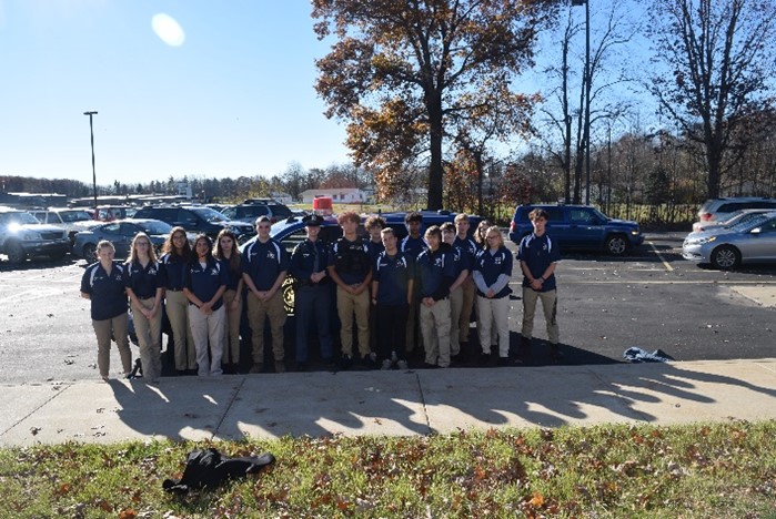 Photo of AM or PM class standing outside in their uniform of polo shirt and kakhi pants