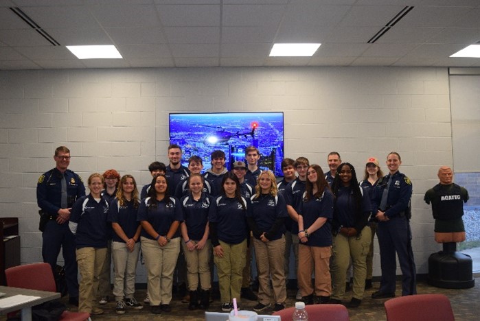 Photo of AM or PM class inside wearing their uniform of polo shirt and kakhi pants