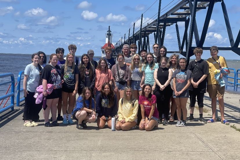 All EC students standing on pier in St Joseph Michigan. Lighthouse in background