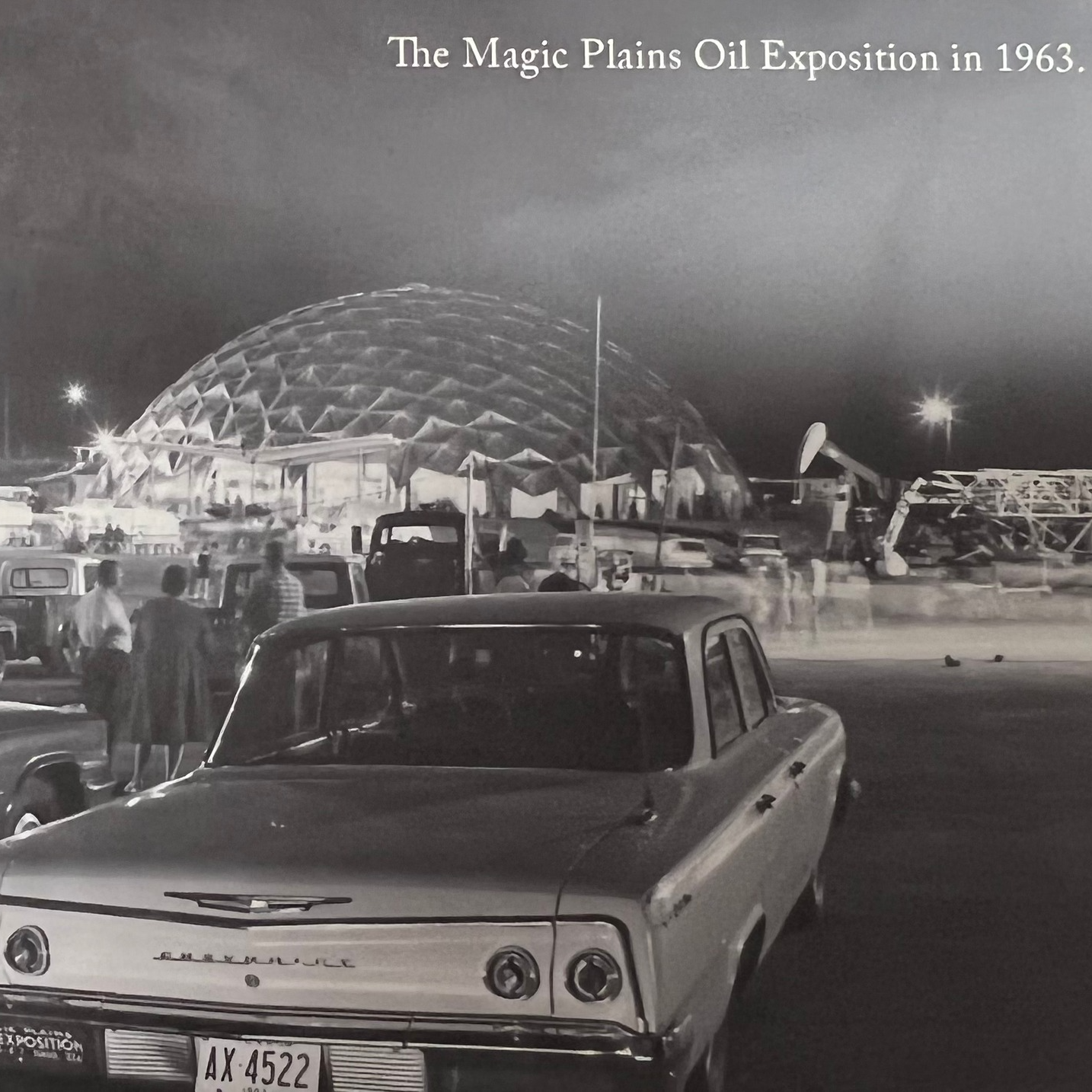 black and white photo of the dome and car with people in the foreground