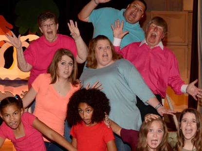 group of adults and kids making silly face for group photo