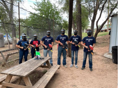 group of kids in paintball gear standing for group photo 