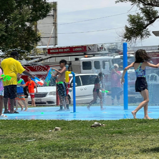 Kids playing outside at splash pad