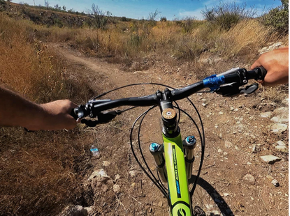 bicycle riding down dirt trail