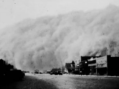 large dust cloud covering buildings and homes 