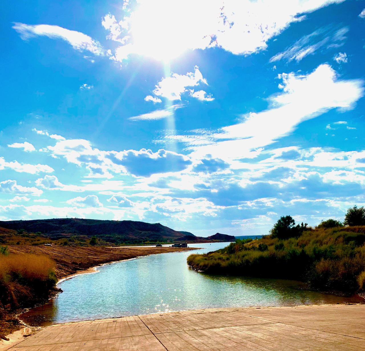 Boat ramp with water in background on sunny day