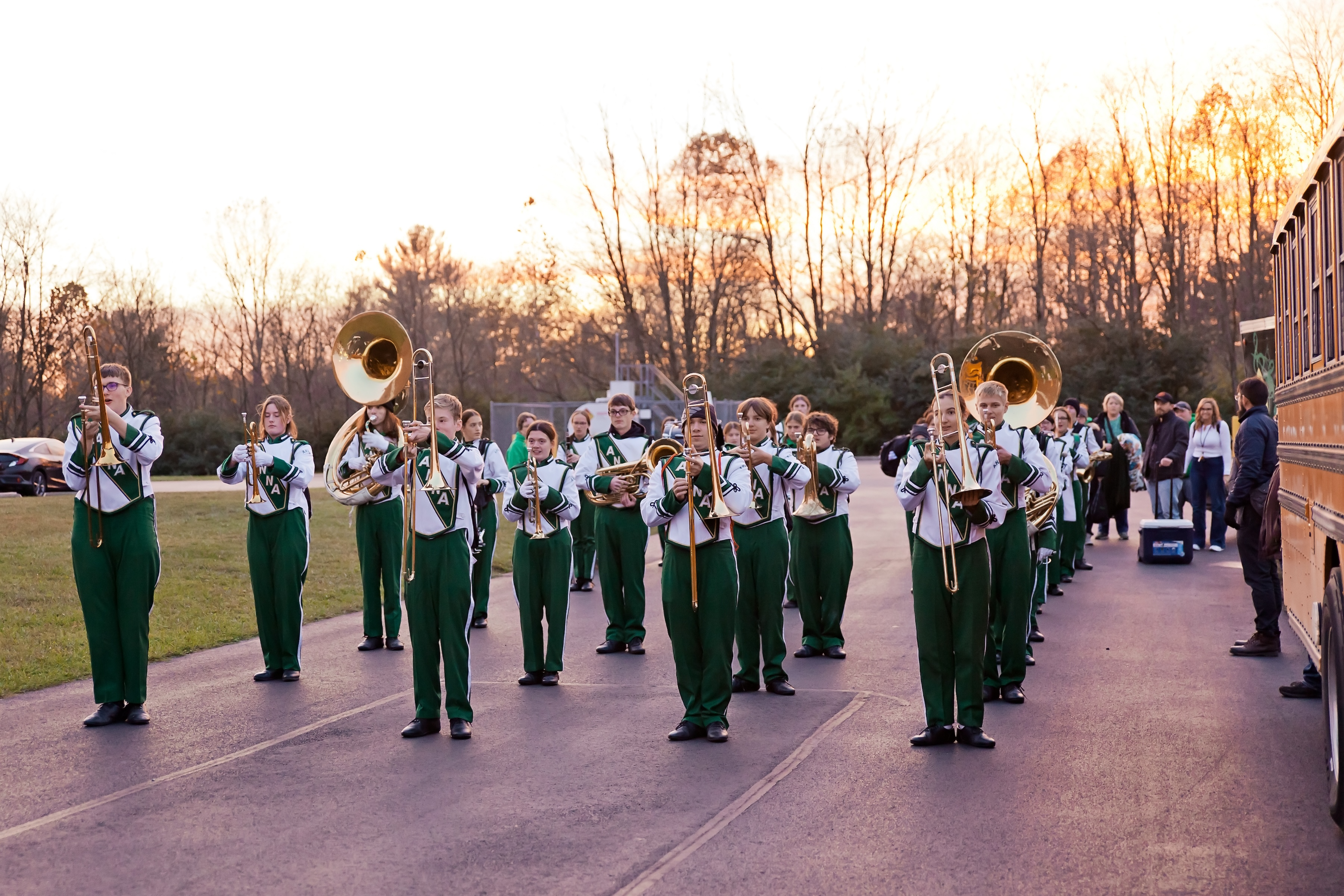 Anna Band lining up in formation next to bus