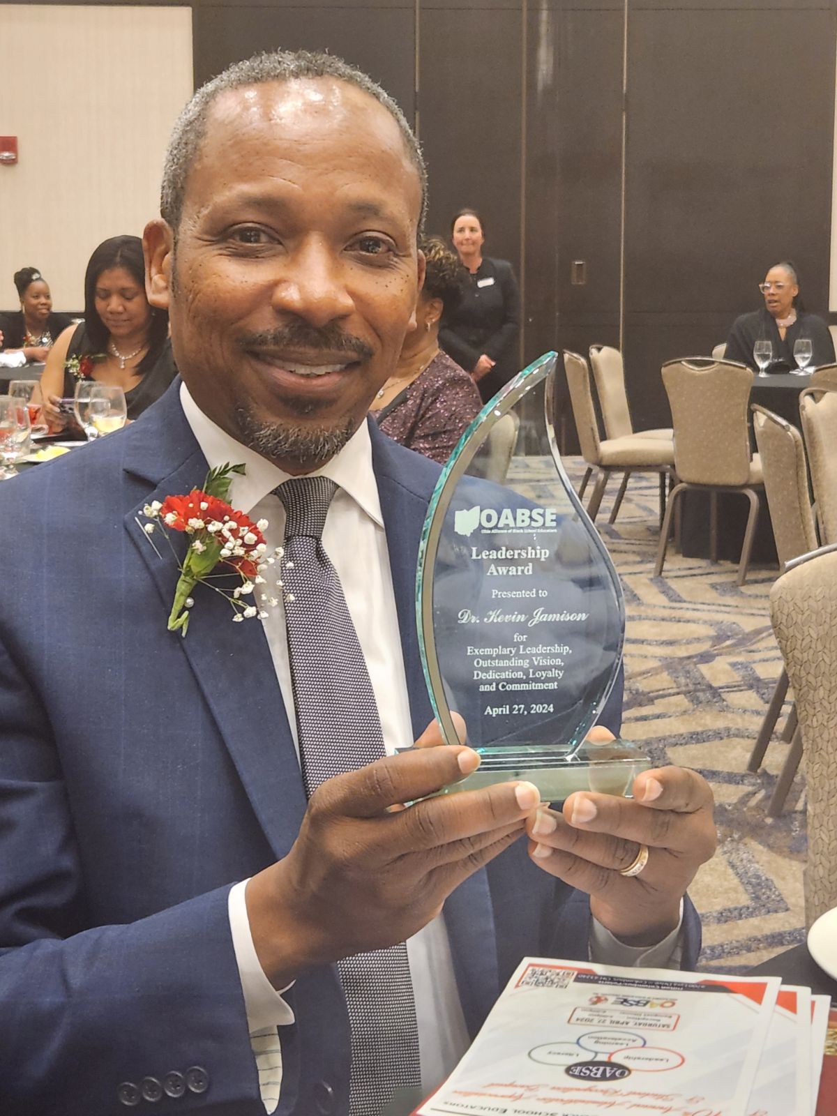 Dr. Kevin Jamison holding OASBE Award