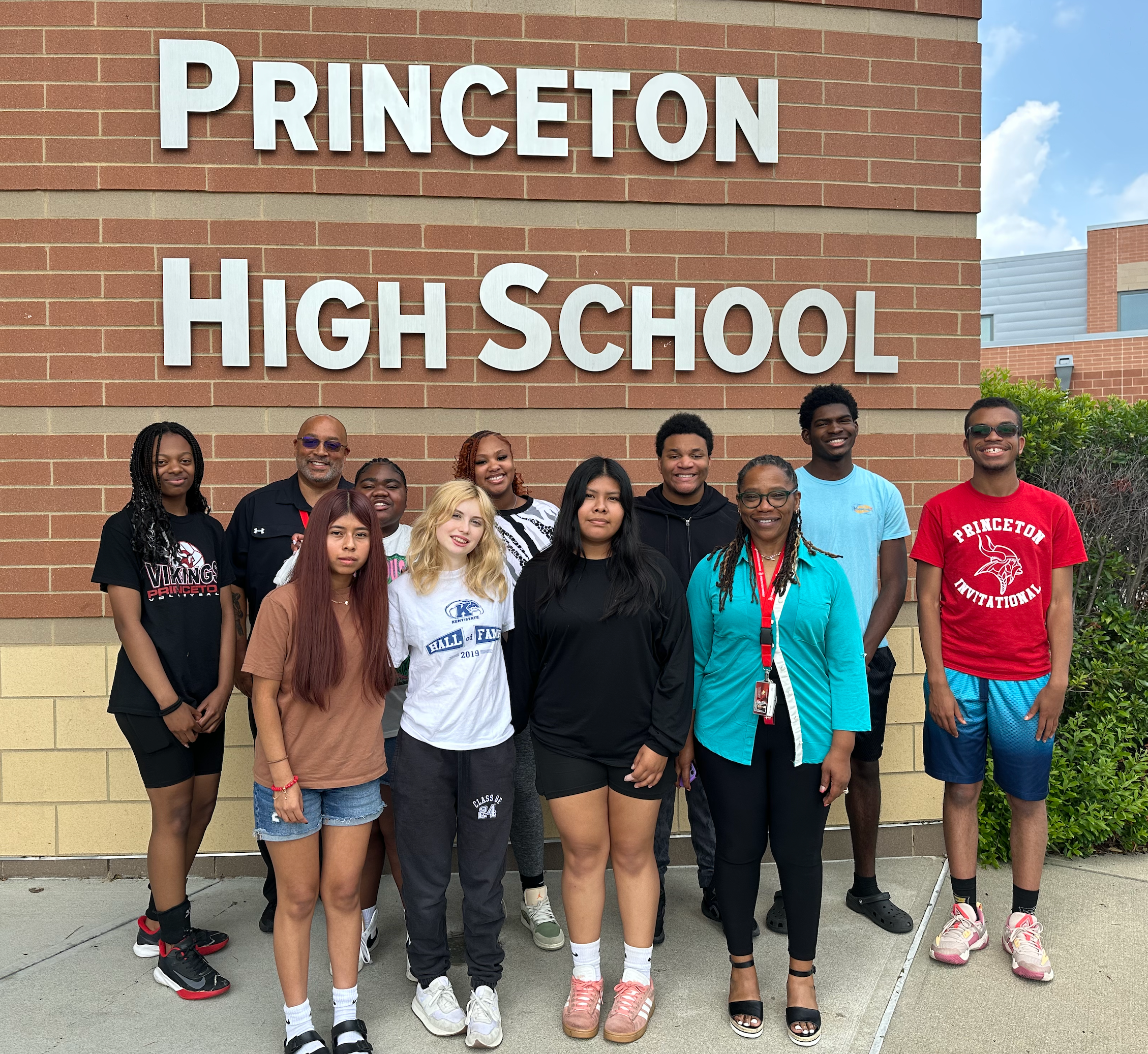 Summer Interns standing with Superintendent Card and Mrs. Tonya Key in front of PHS sign