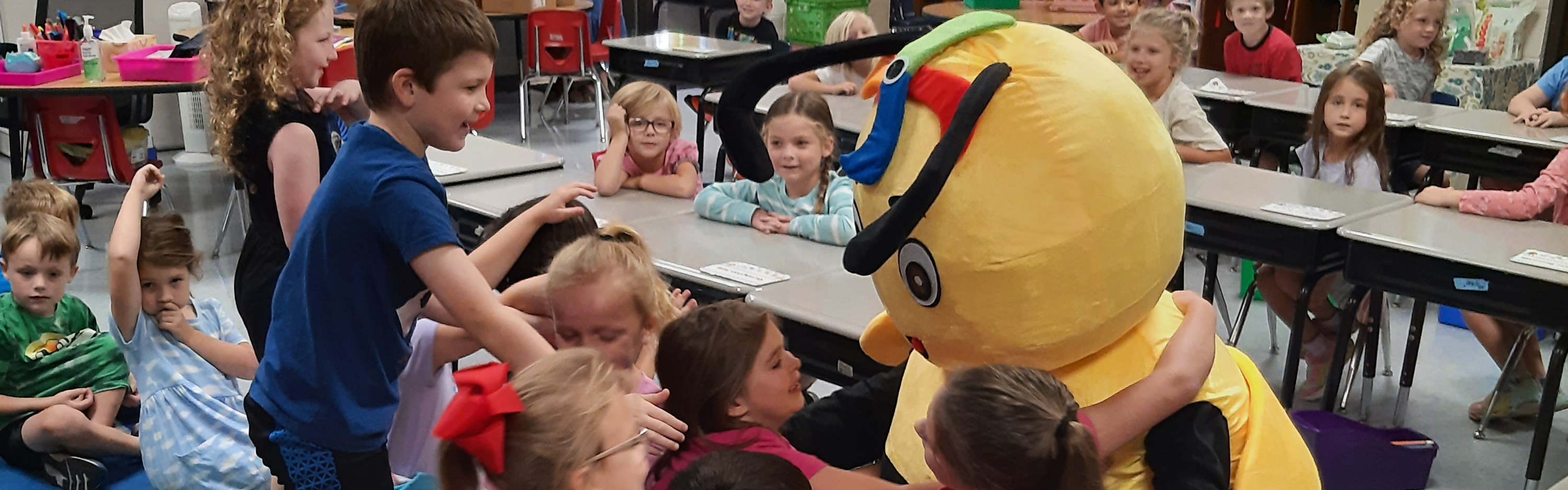 students hug attendance Buzzbee mascot