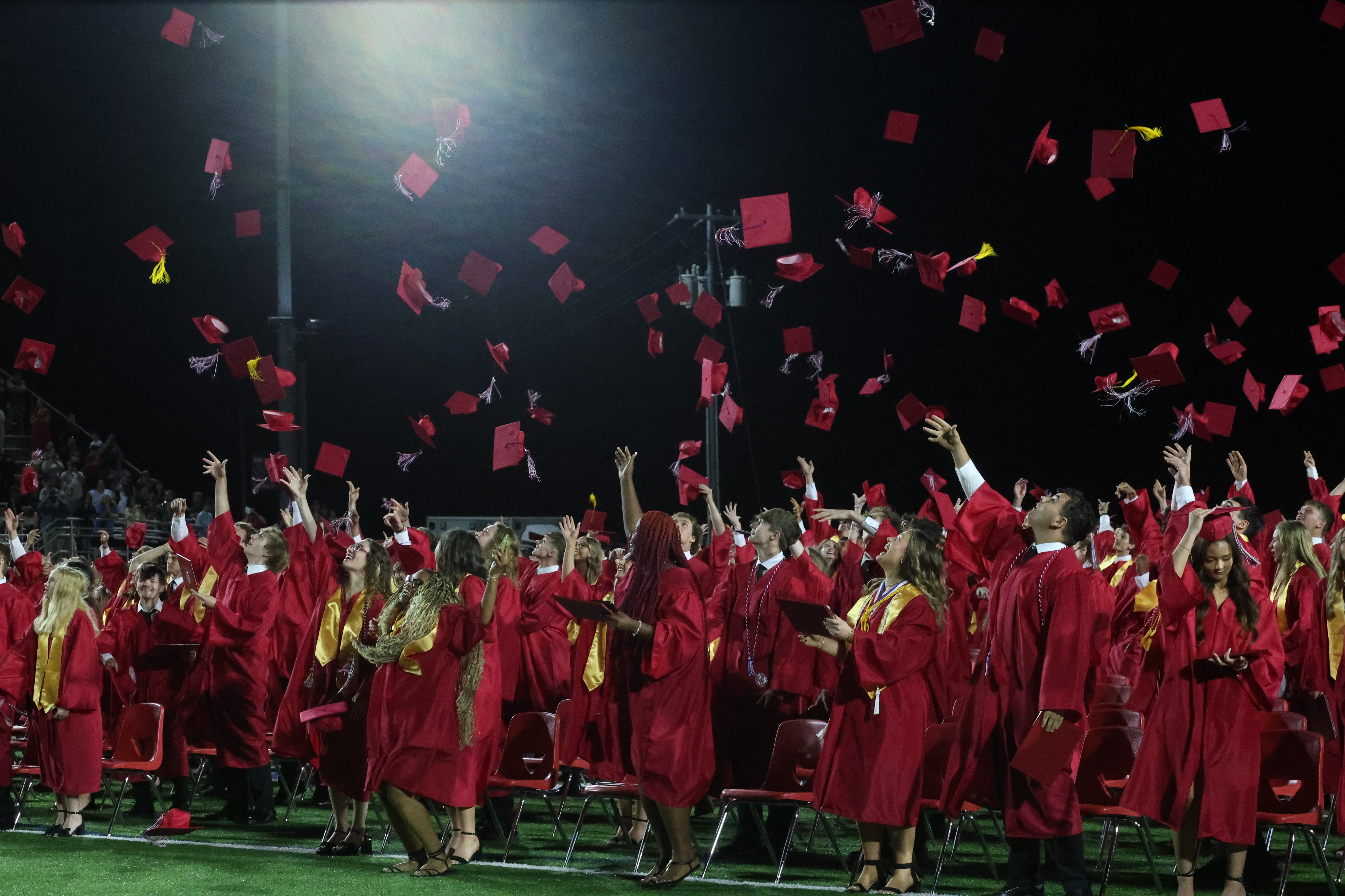 Graduation students throwing caps in the air