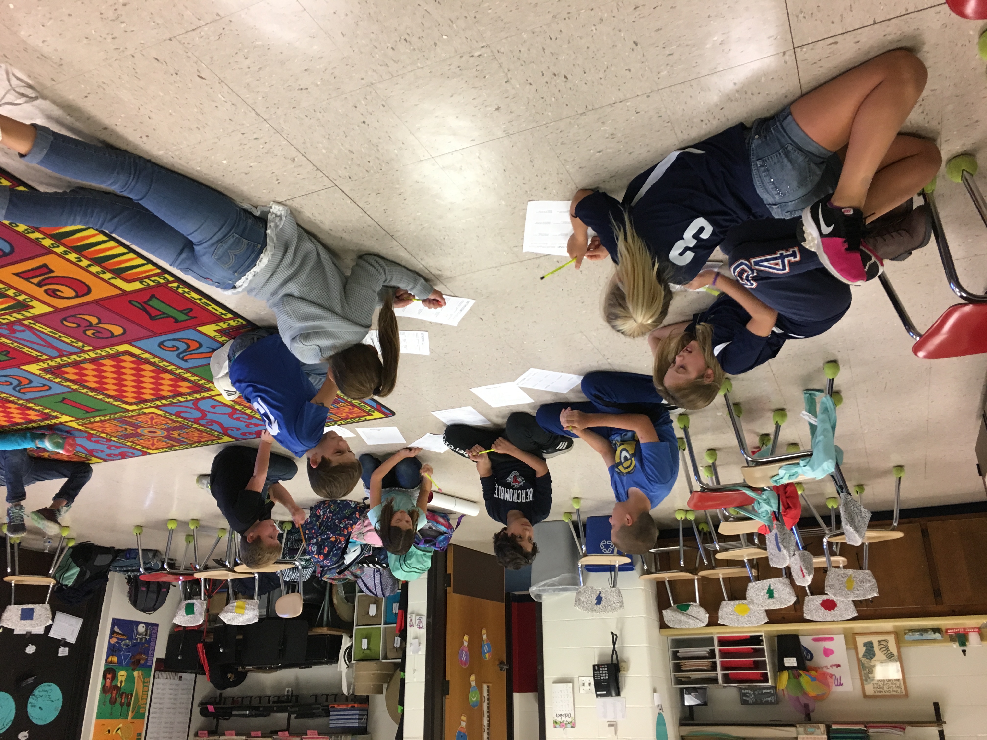 Students are grouped together in various places around the music room writing 2 to 3 person scenes