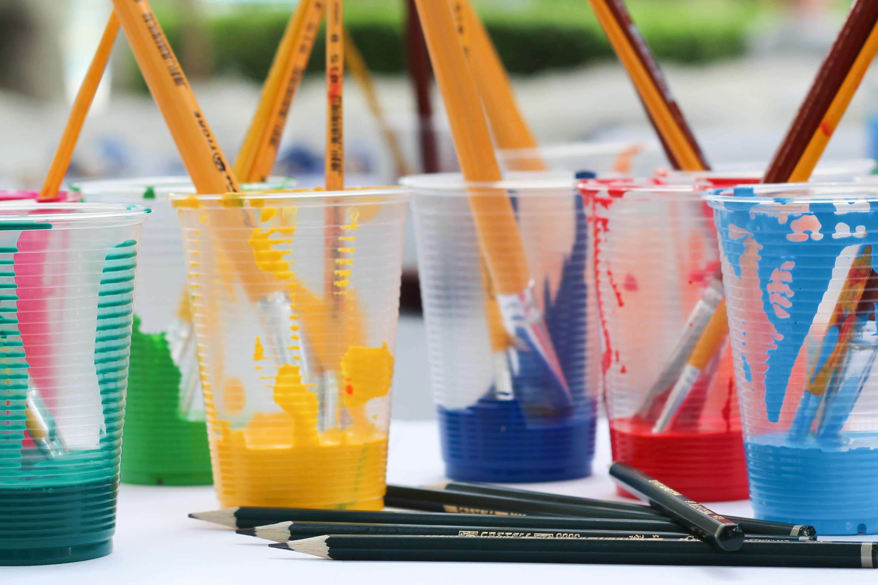 cups with paint and brushes