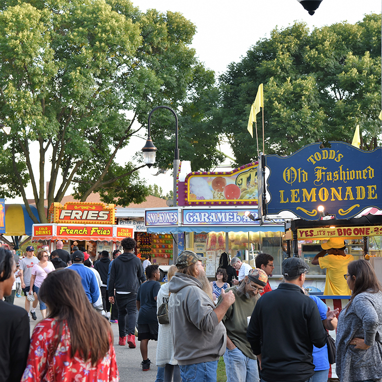 festival food stands with people walking 