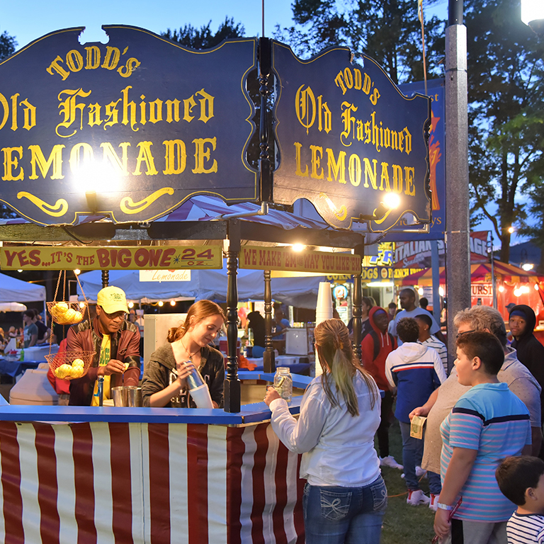 Old Fashioned Lemonade stand with lights and people waiting in line