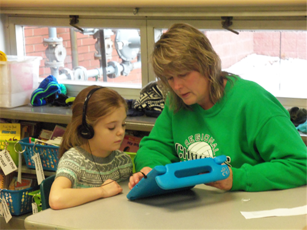 teacher helping a student