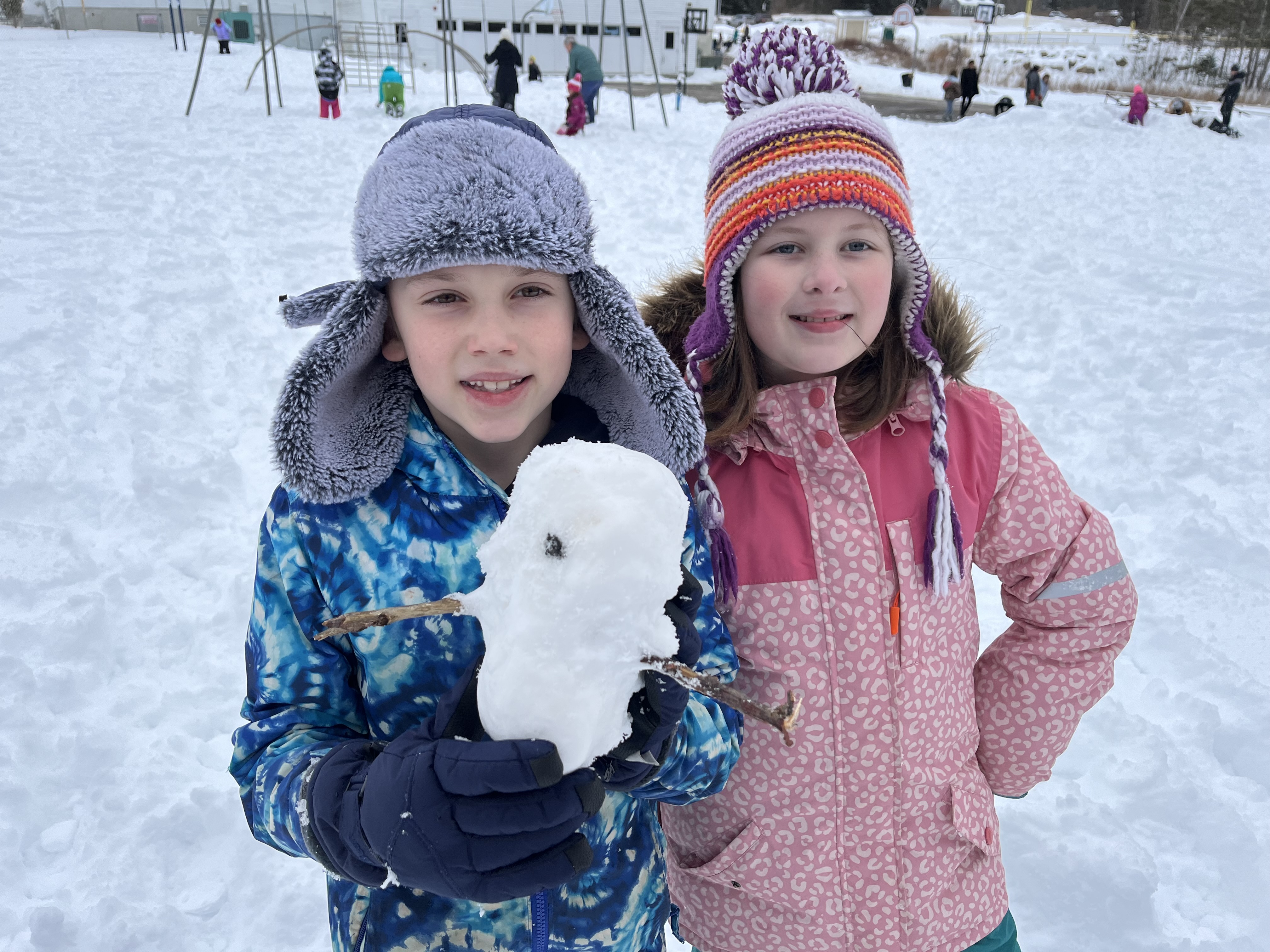 students with tiny snowman